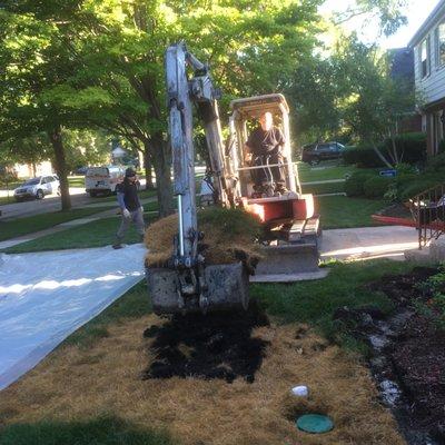 Before image. Notice the dead grass from the leaking underground tank that they are about to remove.