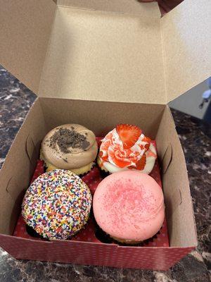 Front left clockwise: birthday cake, vanilla with pink o ing, strawberry shortcake, vanilla with chocolate icing