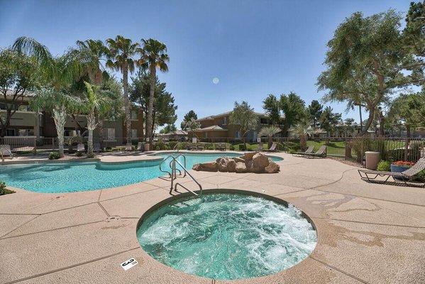 a pool with a hot tub and a swimming pool with trees at Desert Sage