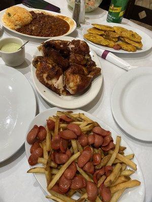 Pollo, tostones, salchipapas, rice and beans.