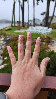 french manicure with highlight jewels on the ring finger of left hand