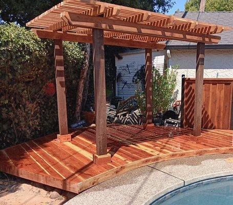 Wood deck with arbor.