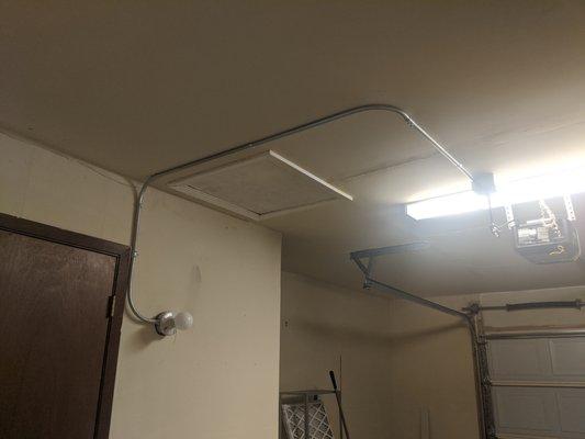 See the pipe and wire run from the wall light to the ceiling outlet.  Notice the hatch to the attic right there above the wall light.