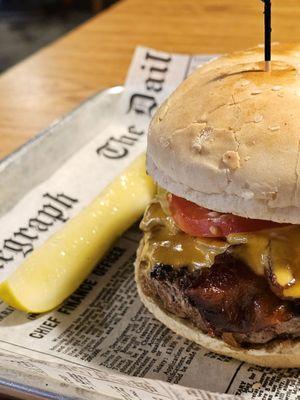 Close-up of the Bacon Cheeseburger and the slice of Dill Pickle.