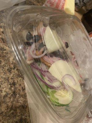 The container of only cheese, meat, onion, olives and cucumber. NO LETTUCE.