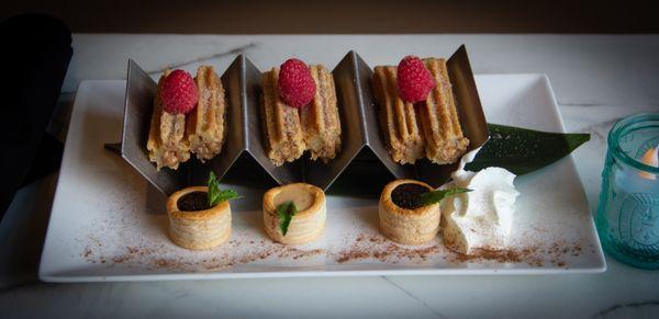 Churros with chocolate, raspberry and caramel sauce