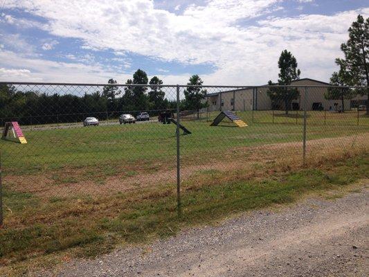 Our outdoor agility field with our building in background