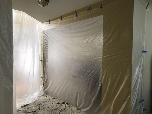 Plastic curtain tapped in open areas of the house connecting with entrance foyer, living and dining room, to protect from prep debris.