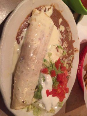 Chicken chimichanga with queso and beans.