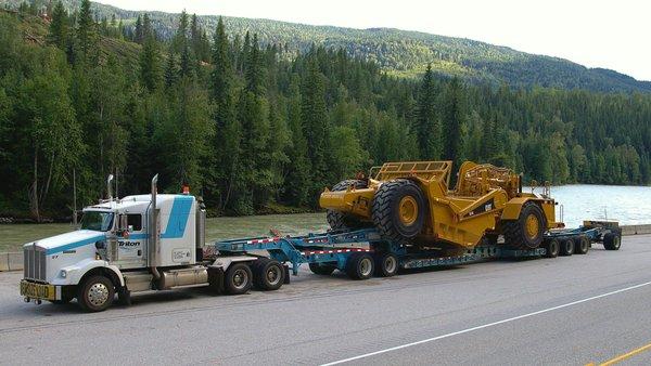 8 axle RGN with stinger hauling a scraper. Very heavy equipment :)