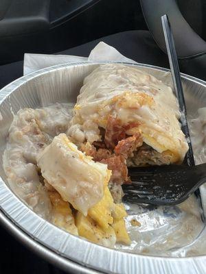 Breakfast burrito with cheese, eggs, sausage, and bacon smothered in gravy!