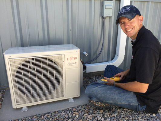 Steve taking a break from installing a Fujitsu outdoor condensing unit to give the camera a smile.