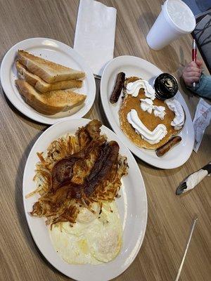 Over medium eggs with well done hashbrowns and bacon, dry rye toast, and the kids chocolate chip pancake with sausage