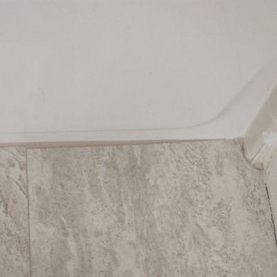 Other poorly cut tile along bathtub