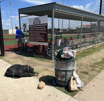 Overflowing trash near field 2 as you walk in.