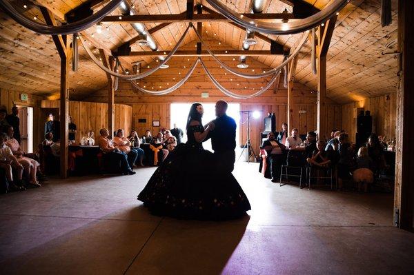 Father and daughter dance inside the building called the Livery.