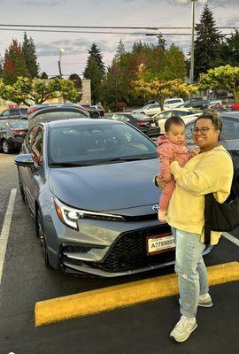 My daughter and grand daughter posing in front of my new Toyota Corolla, from Rodland Toyota of everett