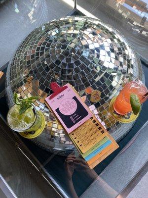 Two of the three mocktails offered, on the cool disco ball table inside