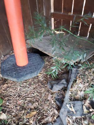 board wedged under my fence.  we dread them returning, if ever they will re-fill the giant hole