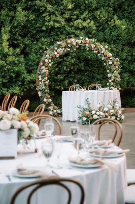 Arch and aisle flowers repurposed for sweetheart table