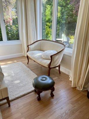 Small pouf/ foot stool in green leather.