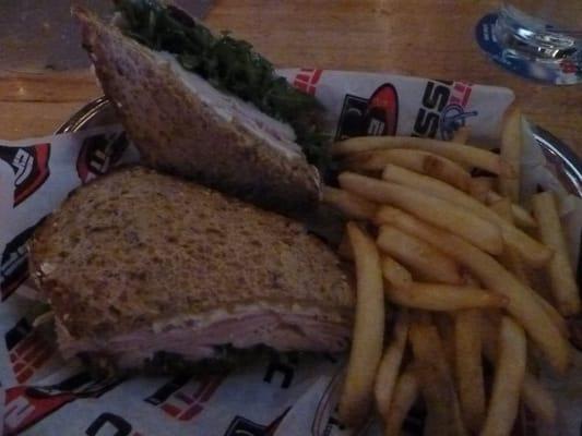 Turkey and brie sandwich with cranberry and french fries