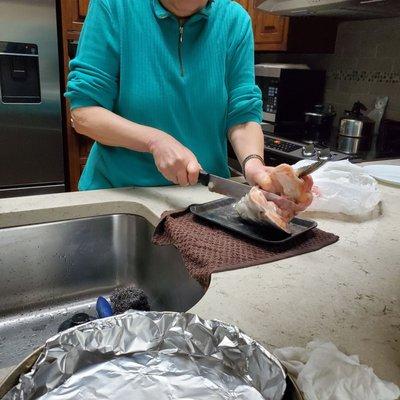 Mom slicing the salmon head that was under a pound (priced at $2.99 a pound).