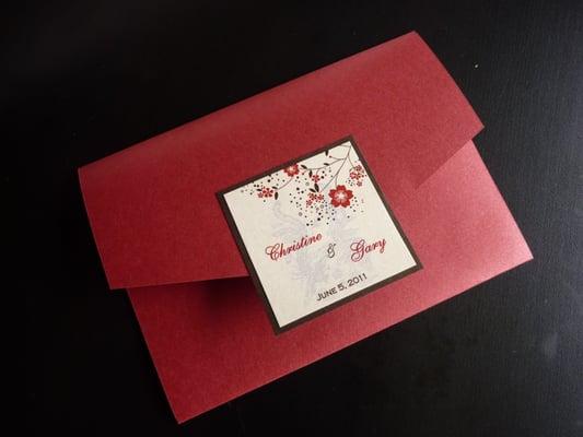 Front of 3 fold wedding invitation.  Detail of pheonix and dragon behind names.