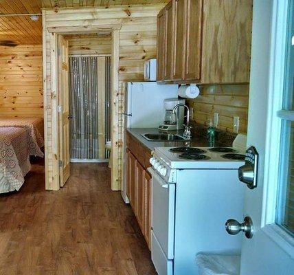 Each cabin has kitchen with dishes and pots and pans