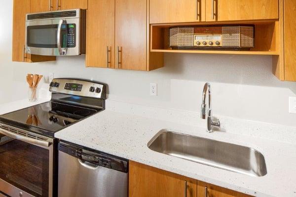 Quartz countertops, handsome cabinetry, extra large sinks