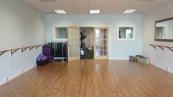 Group fitness and barre studio. Step thru the French door and welcome to the private training studio!