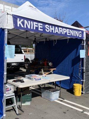 Acme sharpening booth at the San Ramon market.