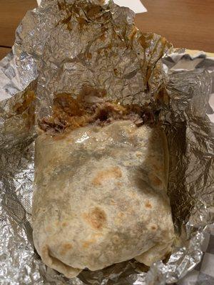 Carnitas burrito drenched in sauce