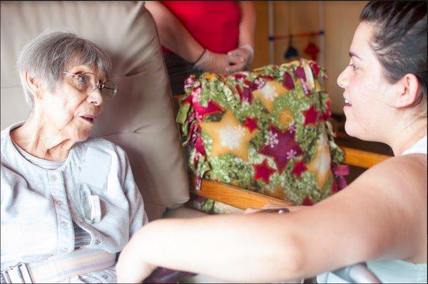 Earthtones music therapist singing with an elder with dementia for engagement, connection, and joy.