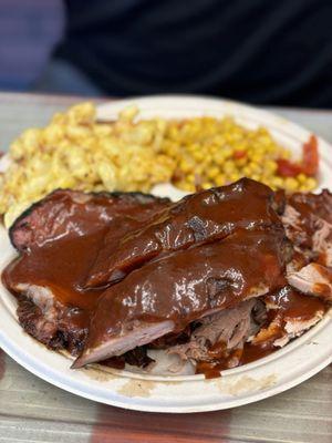 Three meat plate with ribs, brisket, and pulled pork with chili corn and Mac and cheese sides