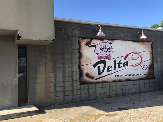 Delta Q sign on the side of the building.