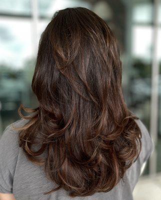 Layered haircut with custom highlights.