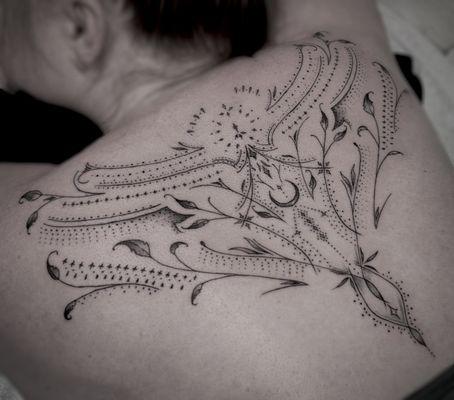 Fine line Ornamental back piece by Ashlo