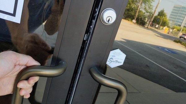 Top and bottom latches of double door were not secured, leaving the door vulnerable to entry.