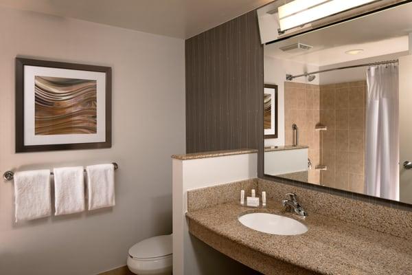 Get ready for the day in redesigned bathrooms with granite countertops, complimentary toiletries and plenty of lighting.