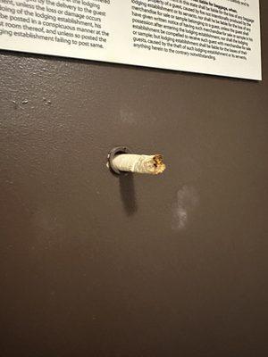 Cigarette butt sticking out of the peep hole. Can't control guests, but housekeeping should have removed it.