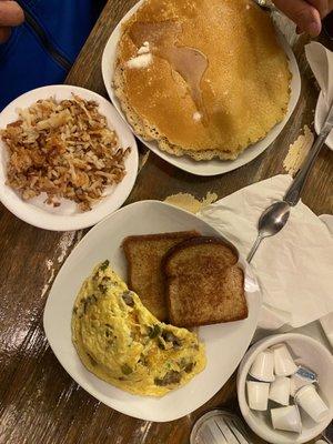 Omelette with sausage, peppers, onion, cheddar cheese with pancakes, hash browns