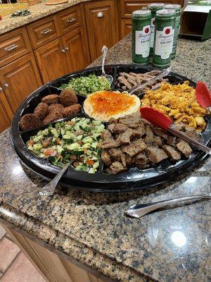 Catering size platter to feed 8 people, comes with rice and couscous sides, pita and sauces