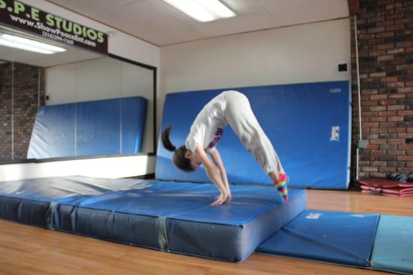 One of our young B-girls doing a forward dive roll onto the mat. She is progressing so fast