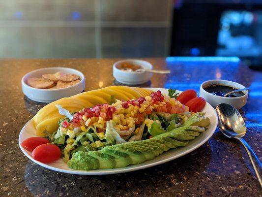 Mango and avocado salad with pomegranate and sweet vinaigrette dressing.