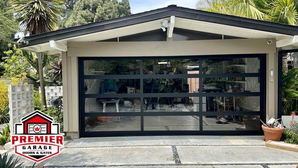 Beautiful Full view garage door installation with black frame and clear glass. Call us for garage door replacement