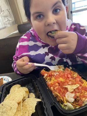 My daughter trying her first Taco Salad from Tasta. I of course had my black olives and sour cream on the side ready to add lol