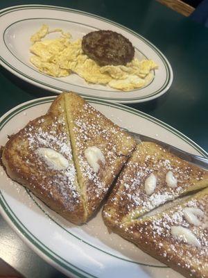 French Toast topped with powdered sugar, turkey sausage and scrambled eggs with cheese.