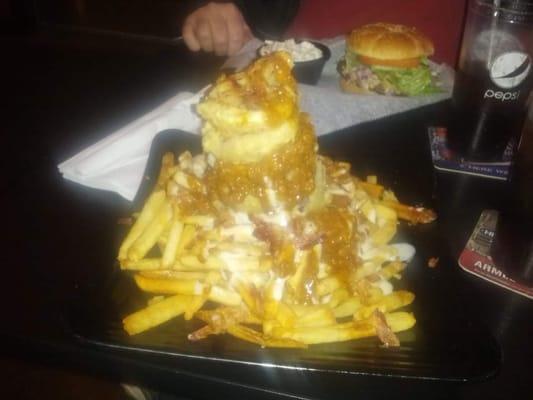 The Tower. Hamburger topped with chili, cheese, fries & onion rings.