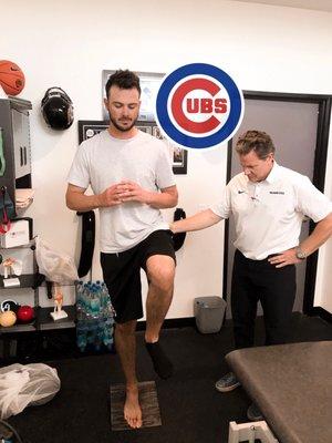 Kris Bryant from the Chicago Cubs working on balancing with Therapist and Owner Scott Pensivy